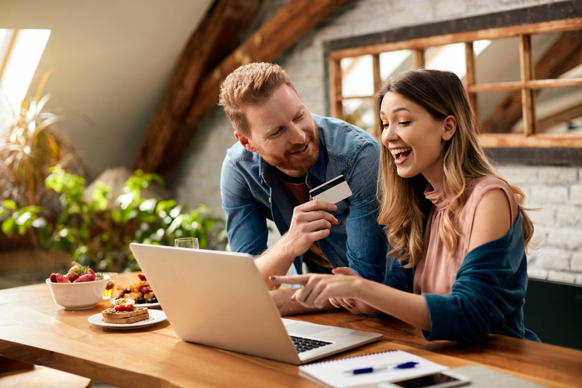 Couple making a payment at a checkout terminal